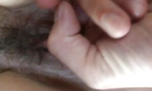 Fingering her hairy pussy...