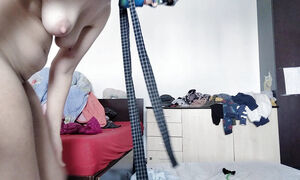Sexy mom has fun trying on clothes and cutting them.