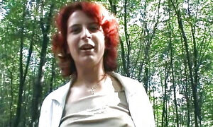A redhead German woman loves masturbating in the forest