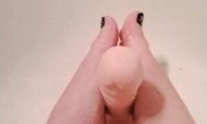 Lubed up dildo gets a sloppy footjob in the shower