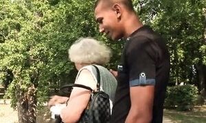 Spring. Grandmother Norma feeds ducklings